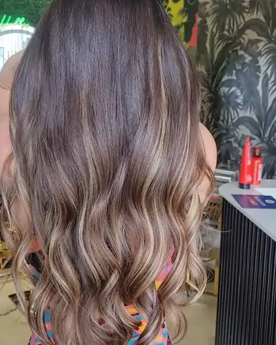 Dark roots melting into light caramel ends